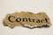 Cancelled agreement concept: Close up of isolated crumpled piece of scrap paper with word contract, white background