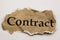 Cancelled agreement concept: Close up of isolated crumpled piece of scrap paper with word contract, white background