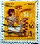 A cancelled postage stamp printed in Egypt features a slave bearing votive fruit offering, mural, circa 1985