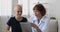 Cancer patient listen doctor holding tablet showing chemo test results