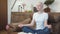 Cancer patient woman sits on a sofa and meditates