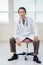 Cancer Specialist Sitting On Chair In Hospital