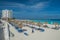Cancun, Mexico - June 12, 2013: Straw sun umbrella on cancun beach, vacation rest, blue caribbean sea