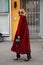 Candela Novembre poses for photographers with long red fur coat before Emporio Armani fashion show, Milan