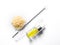 Candelilla Wax in Chemical Watch Glass, yellow cosmetic liquid oil and test tube place next to stirring rod. Chemicals for