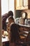 Candid asian family mother and two daughters in kitchen at home in backlight, cozy apartment lifestyle, selective focus