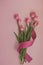 Candid bouquet of pink tulips on pastel background