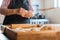 Candid Capture of Unidentified Latina Woman Crafting Dough with Hands and Rolling Pin in Rustic Home Kitchen