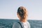 Candid photo of young woman`s head looking at the sea