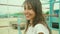 Candid portrait joyful brunette woman smiling to camera and looking happy, standing at old street workout and sports