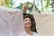 Candid real life portrait of young adult beautiful attractive caucasian woman hanging up fresh washed family clothes on