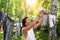 Candid real life portrait of young adult beautiful attractive caucasian woman hanging up fresh washed family clothes on