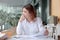 Candid shot of attractive young Asian business woman thinking and resting one`s eyes on the desk in office.