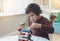 Candid shot of cheerful little boy plays colorful wooden blocks in play room, Portrait of child stacking wooden blocks at home,