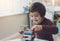 Candid shot of cheerful little boy plays colorful wooden blocks in play room, Portrait of child stacking wooden blocks at home,