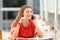 Candid student girl talking on phone in a bar