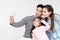 Candid of young attractive happy asian family using smartphone selfie together or video call. Social media community in asian