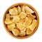 Candied ginger root chunks in wooden bowl over white