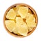 Candied pineapple pieces in wooden bowl over white