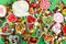 Candies with jelly and sugar. colorful array of different childs sweets and treats on green background