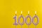 Candle 1000 with flame - Birthday card on yellow luxury background