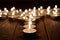 Candle and blurry candles on old wooden background