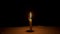 Candle burning and melting, time-lapse, black background, candlelight, flame