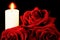 The candle burns brightly against the creative background of red roses. The candle illuminates, a symbol of faith, hope, love,