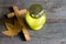 Candle and cemetery cross on wooden background in autumn