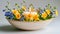 Candle Centerpiece in Ceramic Bowl with Mixed Spring Flowers.Celebration spring holiday Easter, Spring Equinox day, Ostara Sabbat