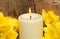 Candle and daffodils closeup