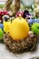 Candle in egg shape on the hay nest