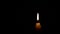 Candle flame on black background. The concept of mourning, grief or sorrow.