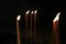 Candle flames on a black background. Burning prayer candles in the church.