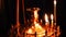 Candle holder with burning candlesticks in the Christian Orthodox Church