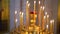 Candle holder with many candles in Church. theme of Christian traditions.