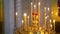 Candle holder with many candles in Church. theme of Christian traditions.