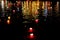 Candle lanterns floating on a river among colorful reflections during night in Hoi An, Vietnam