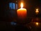 Candle light in the dark. Various brightness from fire. No wind. Copy space.