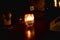 Candle light in glass jar on table decorated in dark night Candle light in glass jar on table decorated in dark night