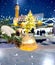 Candle light in snow ,Christmas tree branch with cones  ,winter evening ,people walk in Tallinn old town hall square festive deco