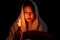 Candle light with young girl praying in dark night background. Woman person worship God with faith and belief. religion, christian