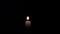 Candle Lightin up - Closeup of a burning orange candle.
