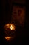 Candle lights with flame glowing on oil in the interior of a church. Symbol of faith and spirit