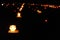 Candle lights on graves in cemetery at night on All Saints’ Day (All Souls’ Day, Halloween, Zaduszki)