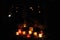 Candle lights on graves and tombstones in cemetery at night in Poland on All Saints’ Day or All Souls’ Day or Halloween