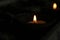 Candle lights on a traditional ceramic bowls on dark background. Holy week concept. Spiritual concepts.