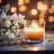 A candle sitting next to a bunch of white flowers