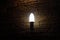 Candle style fluorescent bulb lamp on stone background