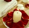 Candle, towel, stones and petals of rose